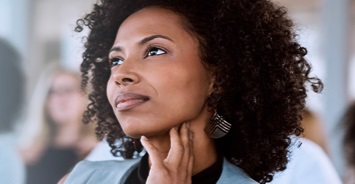 Woman pondering with her hand under her chin