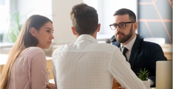 Man and woman discussing with their financial consultant